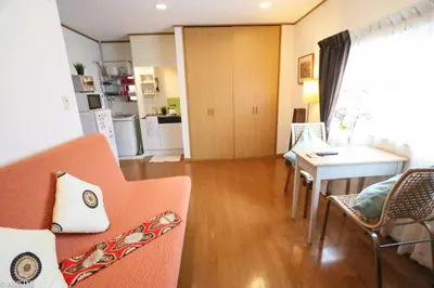 a living room with a couch and a table at Fuji House West Shinjuku in Tokyo