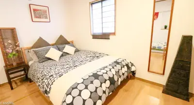 a bedroom with a bed with pillows on it at Fuji House West Shinjuku in Tokyo