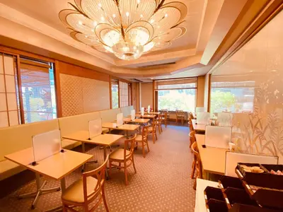 a restaurant with tables and chairs and a chandelier at Smile Hotel Tokyo Nishikasai in Tokyo