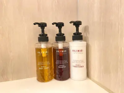 a couple of bottles of oil sitting on top of a sink at Smile Hotel Tokyo Nishikasai in Tokyo