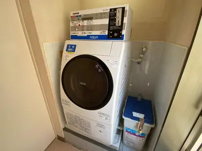 a washing machine with a box on top of it at Smile Hotel Tokyo Nishikasai in Tokyo
