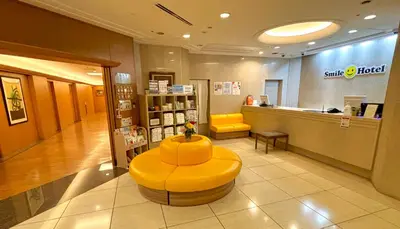 a store with a yellow bench in the middle of a lobby at Smile Hotel Tokyo Nishikasai in Tokyo