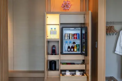 a cupboard with drinks in it in a room at The Okura Heritage Tokyo in Tokyo
