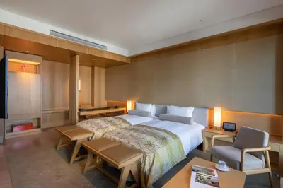 a hotel room with a bed and a tv at The Okura Heritage Tokyo in Tokyo