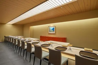 a large room with rows of tables and chairs at The Okura Heritage Tokyo in Tokyo