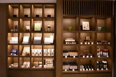 a shelf with bottles of wine in a store at The Okura Heritage Tokyo in Tokyo