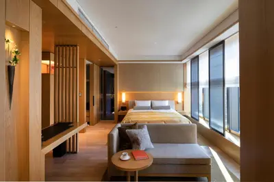 a hotel room with a bed and a couch at The Okura Heritage Tokyo in Tokyo