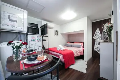 a small room with a bed and a table with a table sidx sidx at North Cottage Studio Apartment with private entrance in Tokyo
