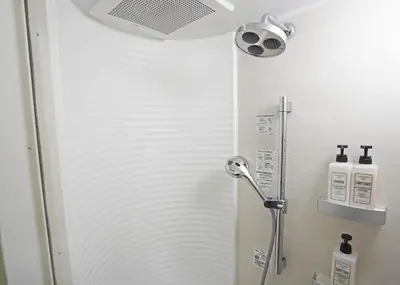 a shower stall with a shower head in a bathroom at Prime Suites Tokyo in Tokyo
