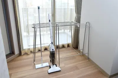 a room with two vacuum cleaners in front of a window at Prime Suites Tokyo in Tokyo