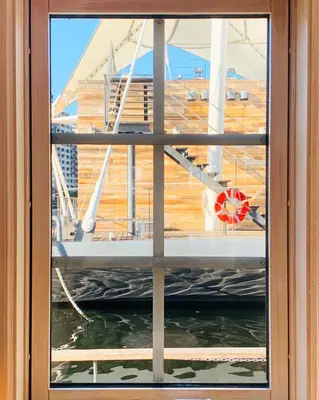 a window view of a dock from a boat at PETALS TOKYO - Floating Hotel in Tokyo
