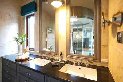 a bathroom with two sinks and a large mirror at PETALS TOKYO - Floating Hotel in Tokyo