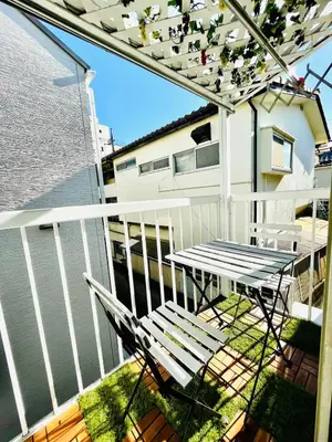 a balcony with a table and chairs and the water at YUYUSO Hostel-SG0165 in Tokyo
