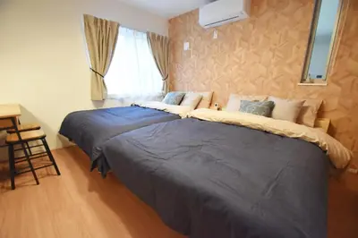two beds in a bedroom with a window at Higashi-Mukojima 2-chome Kodate - Vacation STAY 8987 in Tokyo