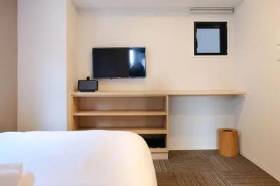 a room with a tv on a shelf with a bed at The Light Inn - Vacation STAY 94704 in Tokyo