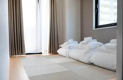 a bed with white pillows in a room with a window at The Light Inn - Vacation STAY 94696 in Tokyo