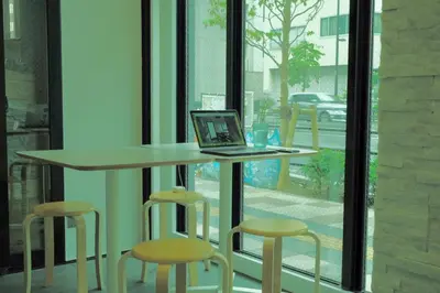 a laptop computer sitting on a table in front of a window at The Light Inn - Vacation STAY 94696 in Tokyo