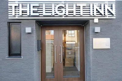 a entrance to a building with a sign above a door at The Light Inn - Vacation STAY 94702 in Tokyo