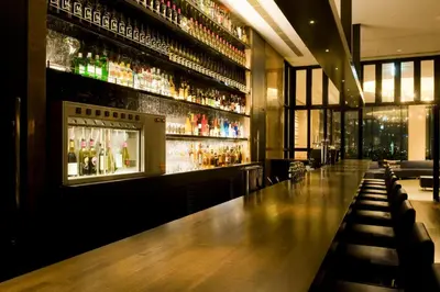 a bar with a long wooden counter in a restaurant at The Gate Hotel Kaminarimon by Hulic in Tokyo