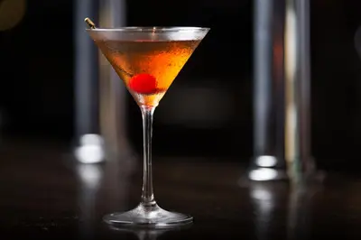 a martini glass with a cherry in it on a table at The Gate Hotel Kaminarimon by Hulic in Tokyo