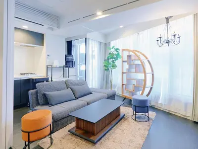 a living room with a couch and a table at Sukumo -\u8485- in Tokyo