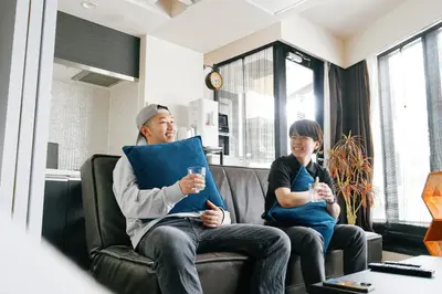 a man and a child sitting on a couch with drinks at Sukumo -\u8485- in Tokyo