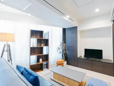 a living room with a table and a tv at Sukumo -\u8485- in Tokyo
