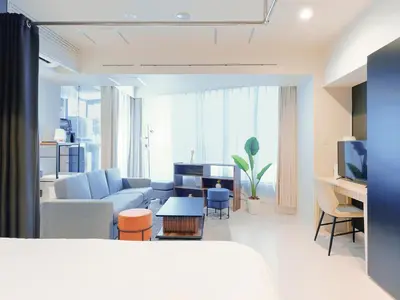 a living room with a couch and a table at Sukumo -\u8485- in Tokyo