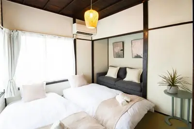 two beds in a room with a window at Close to Shinjuku! 3BR House for 10, Kids Welcome, High-Speed Wi-Fi in Tokyo