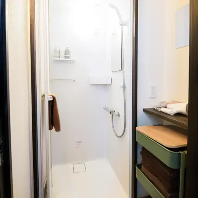a small bathroom with a shower and a sink at Close to Shinjuku! 3BR House for 10, Kids Welcome, High-Speed Wi-Fi in Tokyo
