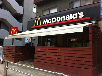a mcdonalds restaurant with a sign on a building at Close to Shinjuku! 3BR House for 10, Kids Welcome, High-Speed Wi-Fi in Tokyo