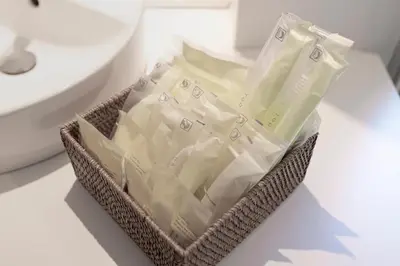 a basket filled with white plastic packets on a counter at NEXUS HOTEL Ebisu in Tokyo