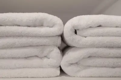 a pile of white towels stacked on top of each other at NEXUS HOTEL Ebisu in Tokyo