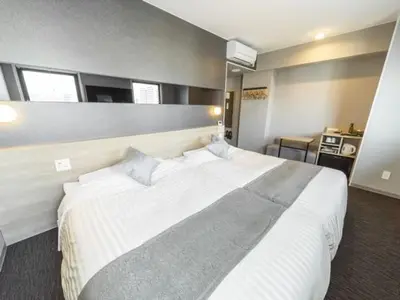 a large white bed in a hotel room at Super Hotel Tokyo Akabane Eki Minamiguchi in Tokyo