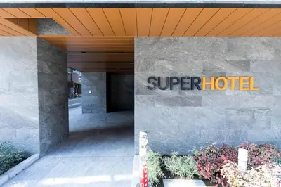 a super hotel sign on the side of a building at Super Hotel Tokyo Akabane Eki Minamiguchi in Tokyo
