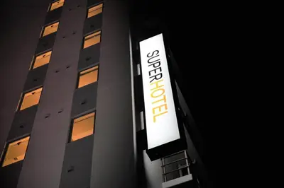 a building with a sign on the side of it at Super Hotel Tokyo Akabane Eki Minamiguchi in Tokyo