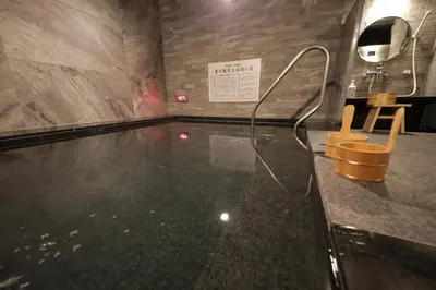 a swimming pool with a table in a room at Super Hotel Tokyo Akabane Eki Minamiguchi in Tokyo