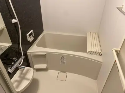 a small bathroom with a toilet and a bath tub at Holy House in Tokyo