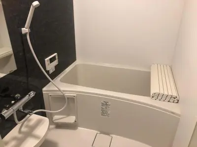 a bathroom with a white tub and a toilet at Holy House in Tokyo