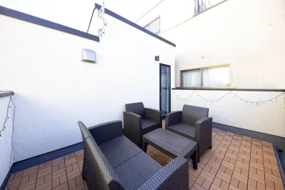 a waiting room with chairs and a table at Holy House in Tokyo