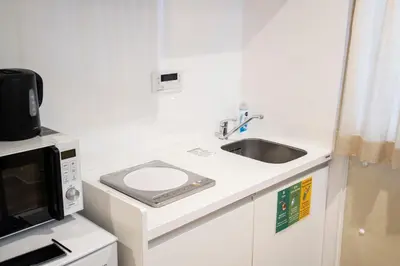 a small kitchen with a sink and a microwave at TOGOSHI 568 STAY Togoshi Ginza in Tokyo