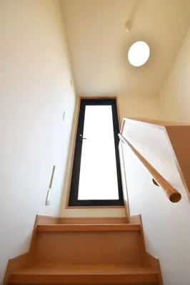a staircase with a large window in a house at \u62bc\u4e0a\u30cf\u30a6\u30b9 in Tokyo