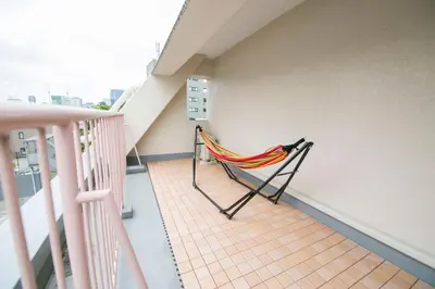 a balcony with a hammock on the side of a building at Shibuya Park Residence Yoyogi Park in Tokyo