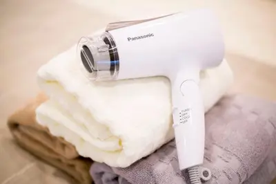 a hair dryer sitting on top of towels at Shibuya Park Residence Yoyogi Park in Tokyo