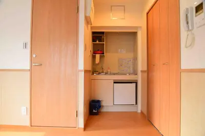 a kitchen with wooden cabinets and a kitchen with a sink at \u4e0a\u91ce\u4e4b\u5bb6\u5206\u9928\u5bb6\u5ead\u623f in Tokyo