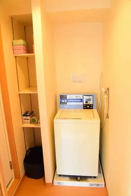 a laptop computer sitting on top of a refrigerator in a room at \u4e0a\u91ce\u4e4b\u5bb6\u5206\u9928\u5bb6\u5ead\u623f in Tokyo