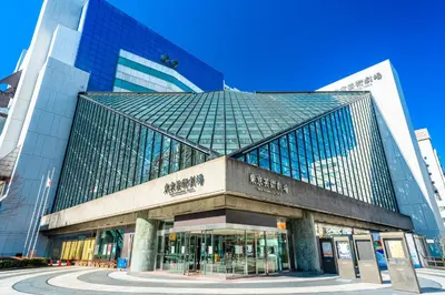 a large glass building in a city at Tabist Hotel Mercury Asakusabashi in Tokyo