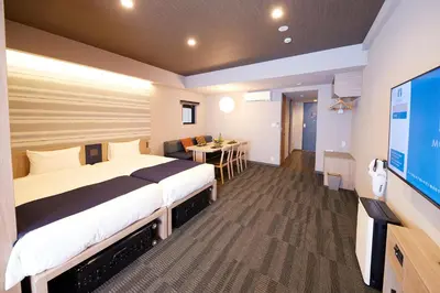 a hotel room with a large bed and a flat screen tv at MONday Apart Premium AKIHABARA ASAKUSABASHI Sta. in Tokyo