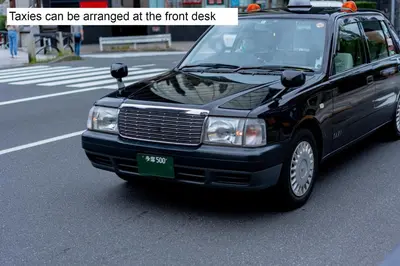 a black car is parked on a city street at MONday Apart Premium AKIHABARA ASAKUSABASHI Sta. in Tokyo