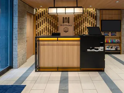 a lobby with a desk with a laptop on it at MONday Apart Premium AKIHABARA in Tokyo